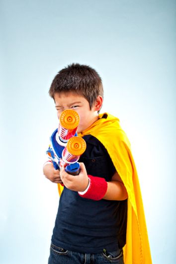 superhero kid pointing his weapon