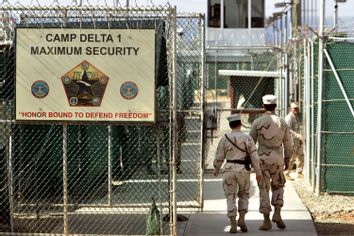 In this June 27, 2006 file photo US military guards walk within Camp Delta military-run prison, at the Guantanamo Bay US Naval Base, Cuba