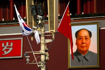 Security cameras on a pole in front of the giant portrait of former Chinese chairman Mao Zedong at Beijing's Tiananmen Square January 9, 2012.