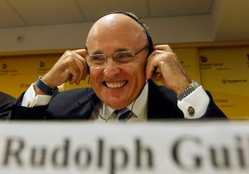 Former New York mayor, Rudy Giuliani, adjusts his headphones during a news conference in Belgrade