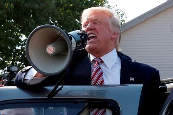 Republican presidential nominee Donald Trump speaks to supporters through a bullhorn during a campaign stop at the Canfield County Fair in Canfield