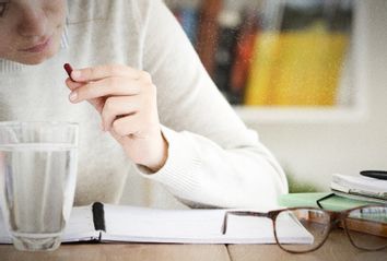 Student Taking a PIll