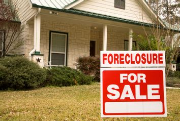 Foreclosure for sale sign in front of house 