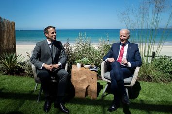 U.S. President Joe Biden and French President Emmanuel Macron speak at a G7 summit on June 12, 2021.