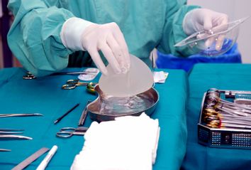 Nurse prepares breast implant for surgery