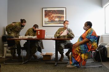 Members of the Missouri National Guard work to administer the Covid-19 vaccine during a vaccination event on February 11, 2021 at the Jeff Vander Lou Senior living facility in St Louis, Missouri.