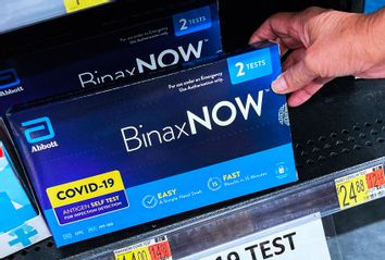COVID-19 home rapid test kits are seen on a shelf at a Walmart