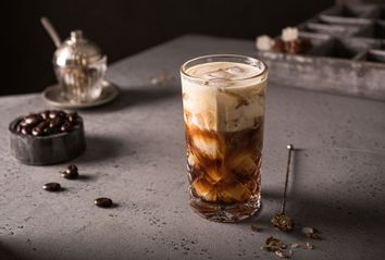 Cold brew coffee with milk and ice cubes