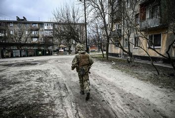 A Ukraine army soldier walks in the town of Schastia, near the eastern Ukraine city of Lugansk, on February 22, 2022