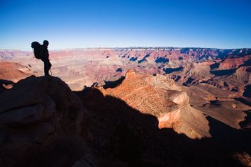 Silhouetted hiker overlooks Arizona's Grand Canyon