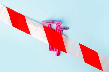 Shaving razors behind caution tape