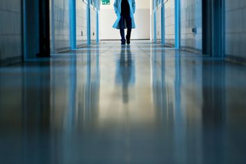 Doctor Walking In Hospital Corridor