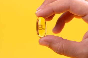 Hand Holding Vitamin B12 capsule