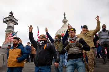 Members of the Proud Boys make a hand gesture while walking near the US Capitol in Washington, DC on Wednesday, January 6, 2021