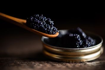 Caviar in a small pot and spoon
