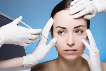 young woman gets a botox injection into the skin