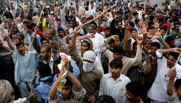 Men shout slogans during a protest rally on the streets of Karachi