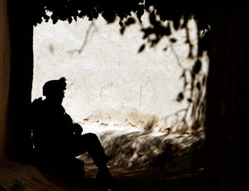 A U.S. Marine takes a break during a patrol in a village in Golestan district of Farah province