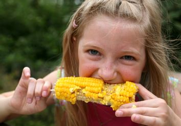 Young Girl Eating Corn