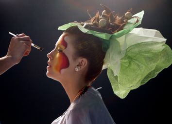 A stylist puts make-up on a model during the Crystal Angel Festival in Kiev