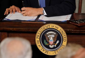 U.S. President Obama signs the healthcare legislation at the White House in Washington