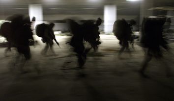 United States Marines from Bravo Co. of the 15th MEU (Marine Expeditionary Unity) march into a barra..