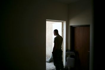 A U.S. soldier stands at the door of a police station, part of the GSS (General Security System), in the southeast of Baghdad