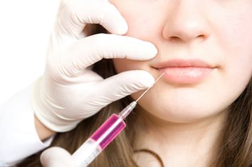 Doctor making injection in women lips