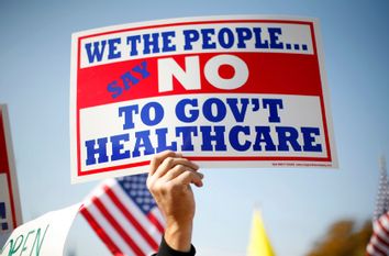 A demonstrator holds up a sign at a rally on healthcare on Capitol Hill in Washington