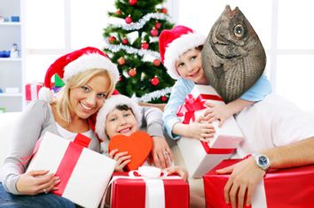 Happy family holding Christmas gift.