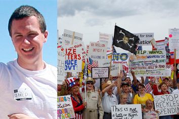 People hold signs during a 