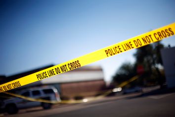 Law enforcement personnel work on a crime scene where U.S Representative Gabrielle Giffords (D-AZ) was shot along with others at a Safeway in Tucson