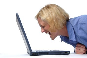 Buisinesswoman screaming at her lap top