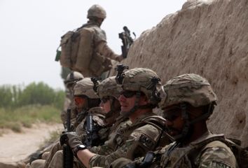 Canadian and U.S. army soldiers attached to 1st Battalion, 22nd royal regiment rest during a patrol in the Panjwai district