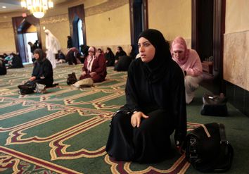 Lamis Ali, 29, arrives for afternoon prayers at the Islamic Center of America in Dearborn