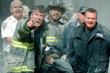 RESCUE WORKERS REMOVE A MAN AFTER WORLD TRADE CENTER HIT BY PLANE.