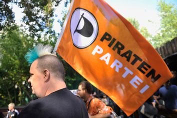 A member of Germany's Pirate Party holds a flag of the party