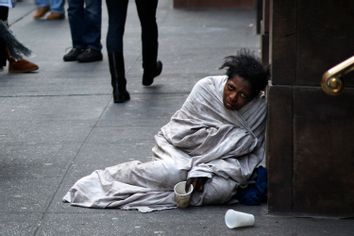 A panhandler begs for money on Fifth Avenue in New York