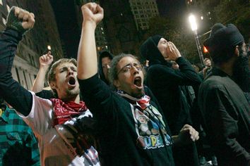 Occupy Wall Street demonstrators chant slogans at a police barricade near the encampment at Zuccotti Park in New York, early Tuesday, Nov. 15, 2011.