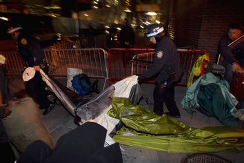 NYPD officers remove the belongings of members of the Occupy Wall Street movement after removing members of the movement from Zuccotti Park in New York