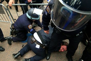 New York City police officers arrest a protestor affiliated with the Occupy Wall Street movement as he tries to return to Zuccotti Park, in New York November 15, 2011.