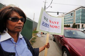 Unemployed Diana Jackson holds up sign