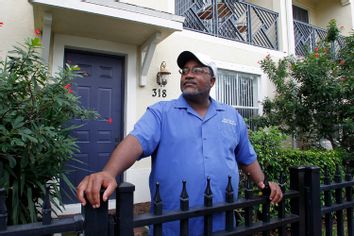 Curtis Jones stands in front of his two-story townhouse in Delray Beach