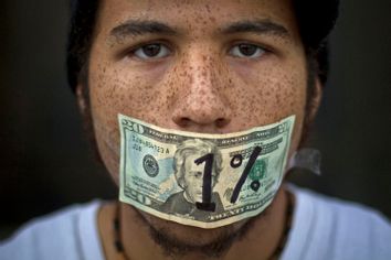 Roshan Bliss, who says he has a debt of $50,000 in school loans, attends an Occupy Denver demonstration in Denver, Colorado