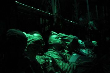 Members of the U.S. military rest on board an Air Force C-130 transport plane marking the end of their presence in Iraq after departing the Baghdad Diplomatic Support Center in Baghdad December 15, 2011.