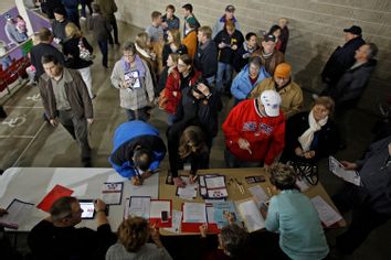 Caucus goers arrive and sign in for the 2012 Iowa Caucus