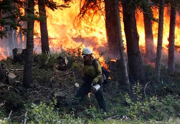 A firefighter works a burnout operation on the north flank of the Fontenelle Fire outside Big Piney, Wyoming
