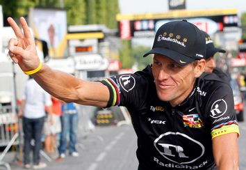 Radioshack team rider Lance Armstrong of the U.S. waves on the Champs Elysees in Paris during the final parade of the 97th Tour de France cycling race