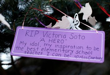 A sign in remembrance of teacher Soto, one of those killed in the December 14 shootings at Sandy Hook Elementary School, hangs from a tree at a makeshift memorial in Newtown