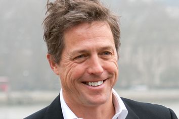 Hugh Grant smiles at a charity photo call in London